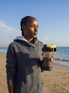 Woman holding protein shake in hand