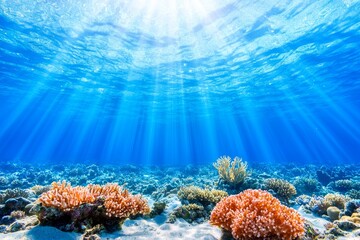 Obraz premium Abstract underwater background with sun rays shining through the water surface. Dark ocean floor with deep blue water and white bubbles.