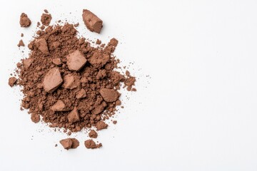 This aerial view shows a field with dry grass among melting snow.