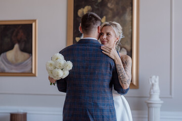 A beautiful young couple, the bride and groom, are standing in an embrace. Family. Wedding. Marriage