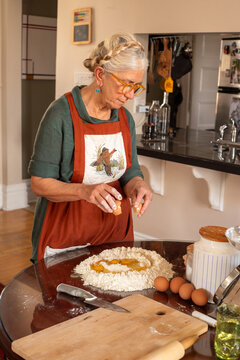 Senior woman home portrait making tagliatelle
