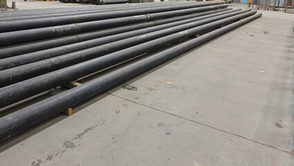 Obraz premium Industrial steel pipes in warehouse with matte finish and markings dust and footprints on floor
