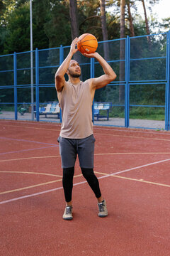 Athlete on court focusing on target before making basketball shot