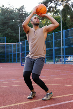 Athlete performing two-handed set shot on outdoor court 