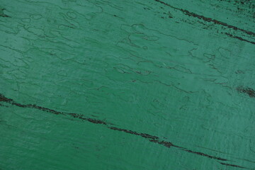 texture of putty painted gree gently orange painted wall green plaster background, pastel lidgh...
