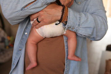 Father Holds His Baby Up against Him