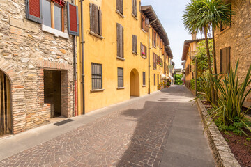 Fototapeta premium Picturesque small town street view in Sirmione, Lake Garda Italy.
