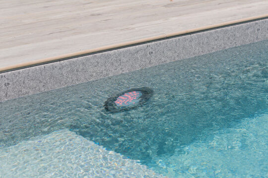 Swimming pool with underwater light LED near wooden deck