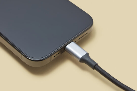 Black wire plugged into socket of turned off cellphone