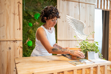 Art gallery owner arranging her eco friendly workplace