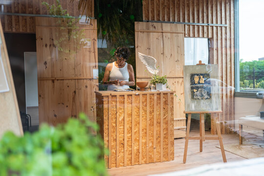 Art gallery owner arranging her eco friendly workplace