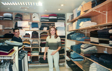 analog image of a couple of workers in a clothing store