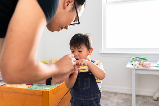 Up close of a dad showing his son something