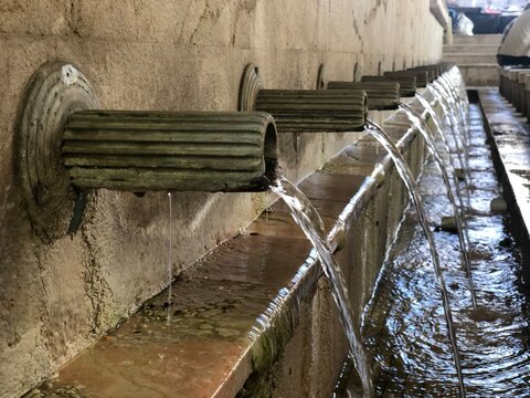Water Flowing from Traditional Stone Fountain