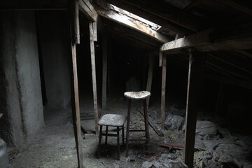 Dusty Attic with Worn Stool and Sunlight