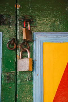  Two Colorful Locks on Wooden Door