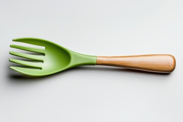 A vibrant green serving fork with a bamboo handle, ideal for showcasing kitchenware in culinary presentations, cooking blogs, or eco-friendly product promotions, Perfect for modern kitchens,