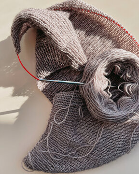 Creating a cozy scarf with soft yarn in sunlight