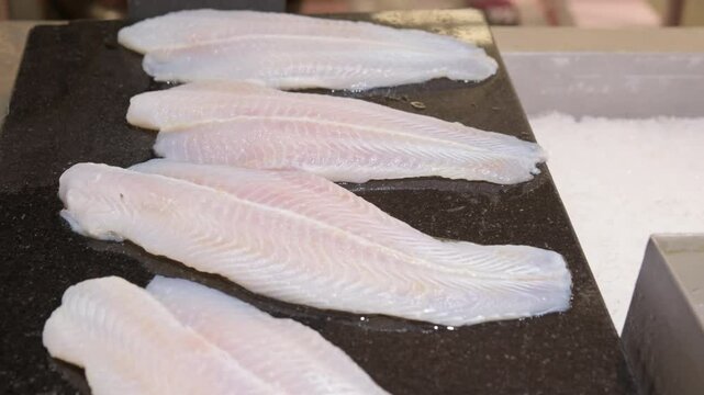 Fresh raw fish fillet on counter close-up.