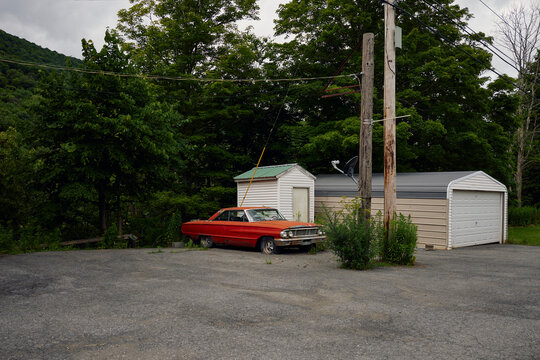 Vintage car next to the garage - Powered by Adobe