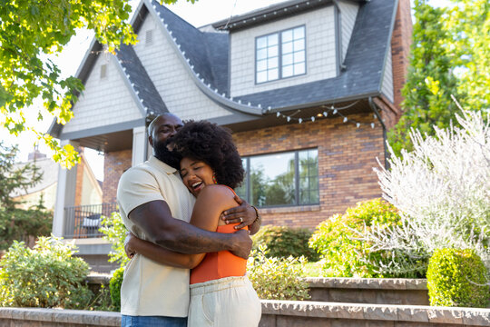 Black family portrait smile  dad with daughter porch of home property