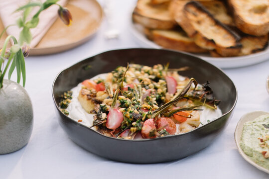 Delicious vegetable dish adorned with fresh herbs.