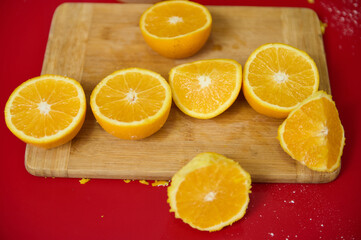 Freshly cut oranges on a wooden board with vibrant background