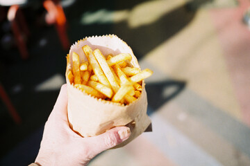 Hand holding bag of chips