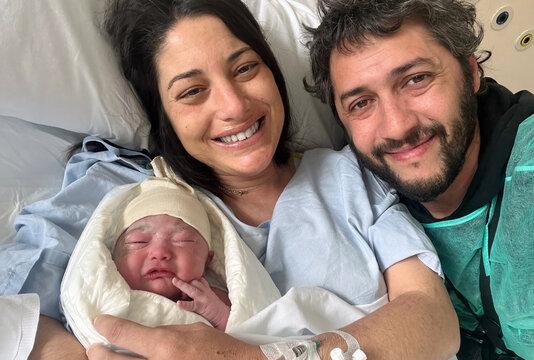 Family with Newborn in Hospital Bed