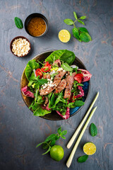 Mixed Thai style green leafy Salad with marinated beef and peanuts served with vinaigrette dressing...