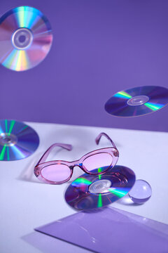 Retro Sunglasses with CDs on a Purple Background