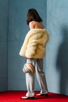 Fashionable Woman in Faux Fur Coat and Stylish Jeans