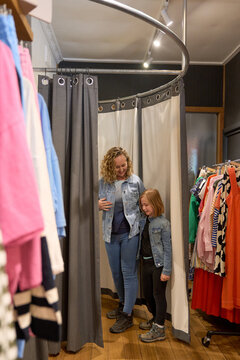 Woman with her daughter in fitting room at boutique shop