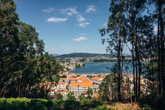 Scenic view of Combarro coastal town with red roofs and forested hills