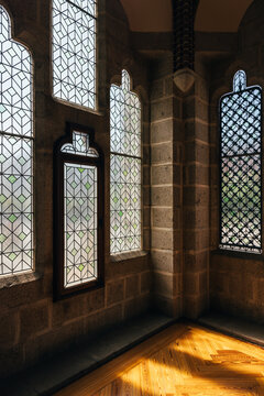 Sunlit room with decorative geometric patterned stained glass windows