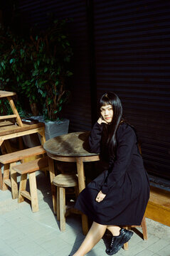 Portrait of a gothic metal girl. Calm mysterious posing. Analogue