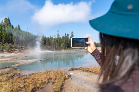 Tourist taking photo cell phone nature