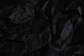 Fototapeta premium Wrinkled black paper texture background with copy space. Concept: Backgrounds, textures, black, stationery.
