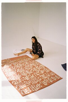 Female calligrapher artist designer working on clothing project
