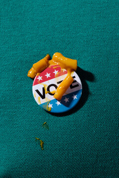 vote badge stained of mac and cheese