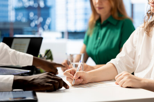 HR manager helped by assistant signing contract after finding best talent to fill open company position. Close up of headhunting colleagues hired to assess skills of candidate, filling paperwork