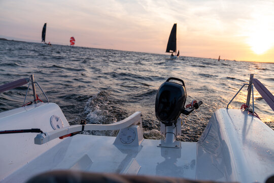 Sailboat with Outboard Motor at Sunset