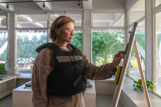 Woman Writing on Whiteboard in Bright Room