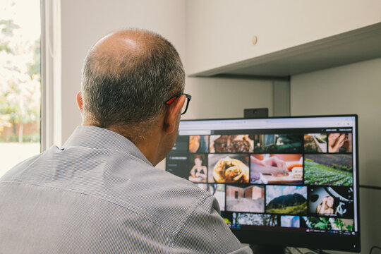 Adult man viewing stock photos