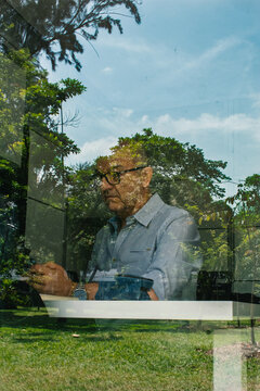 Portrait of an adult man through a window