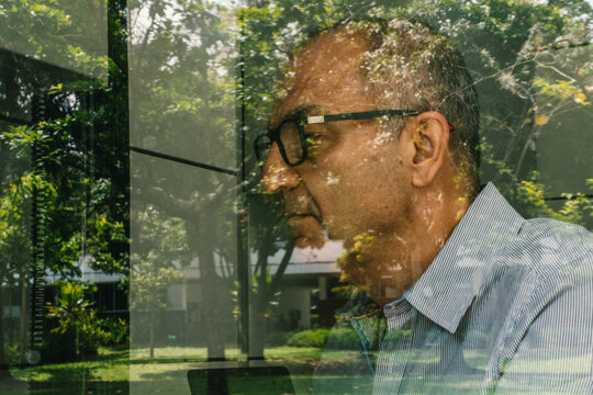Portrait of an adult man through a window