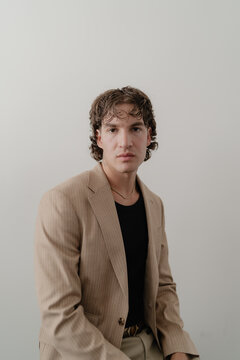 A Portrait Of A Male Model Posing With Stylish Blazer and Black Shirt