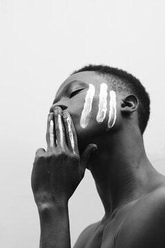 Portrait of Model with white paint strokes on his face 