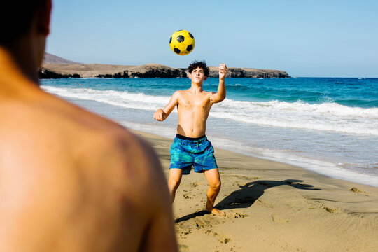 Two friends spend quality time playing freestyle with a soccer ball