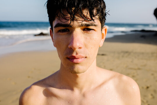 Teenage tourist posing with a serious look on Papagayo beach